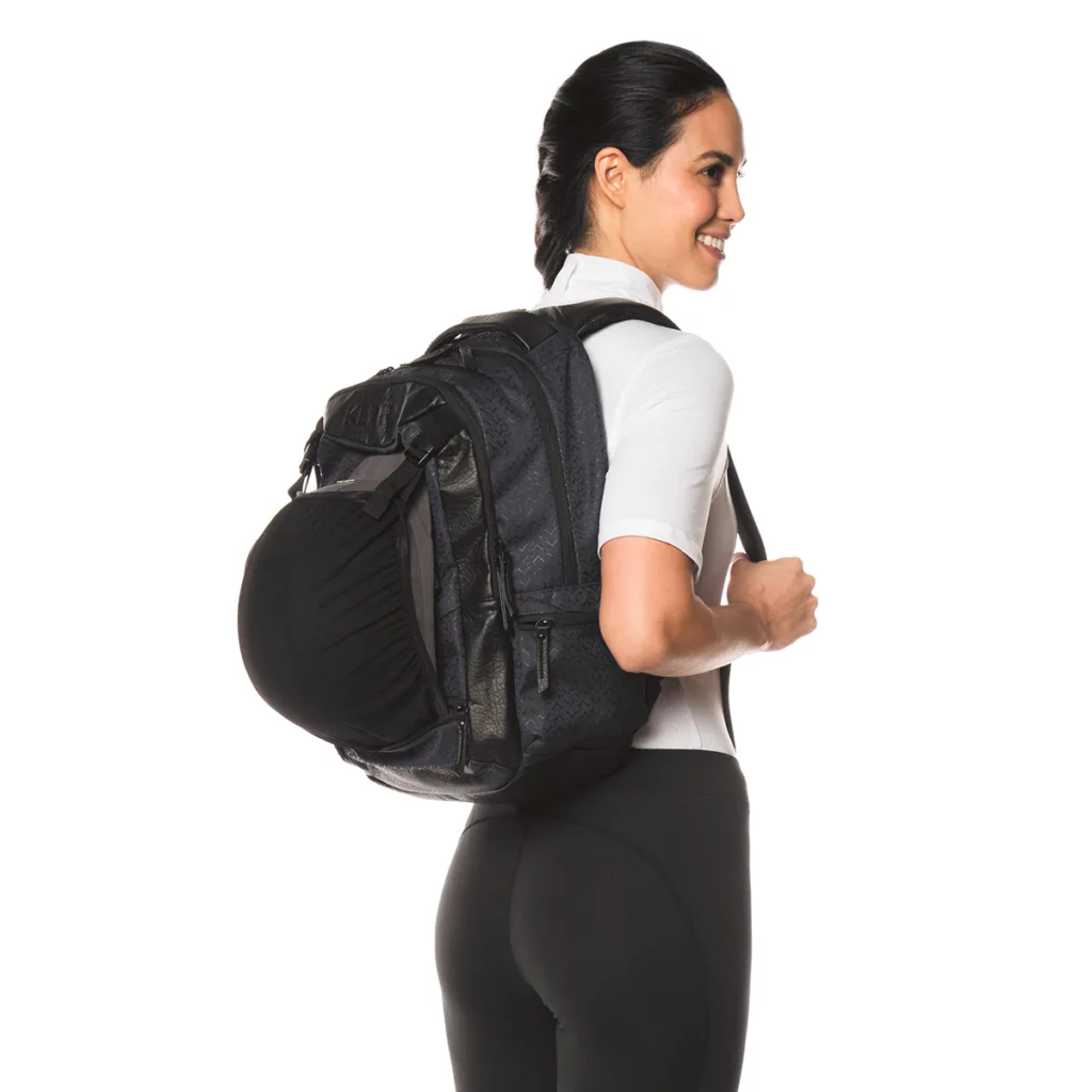 woman wearing black backpack with helmet attached