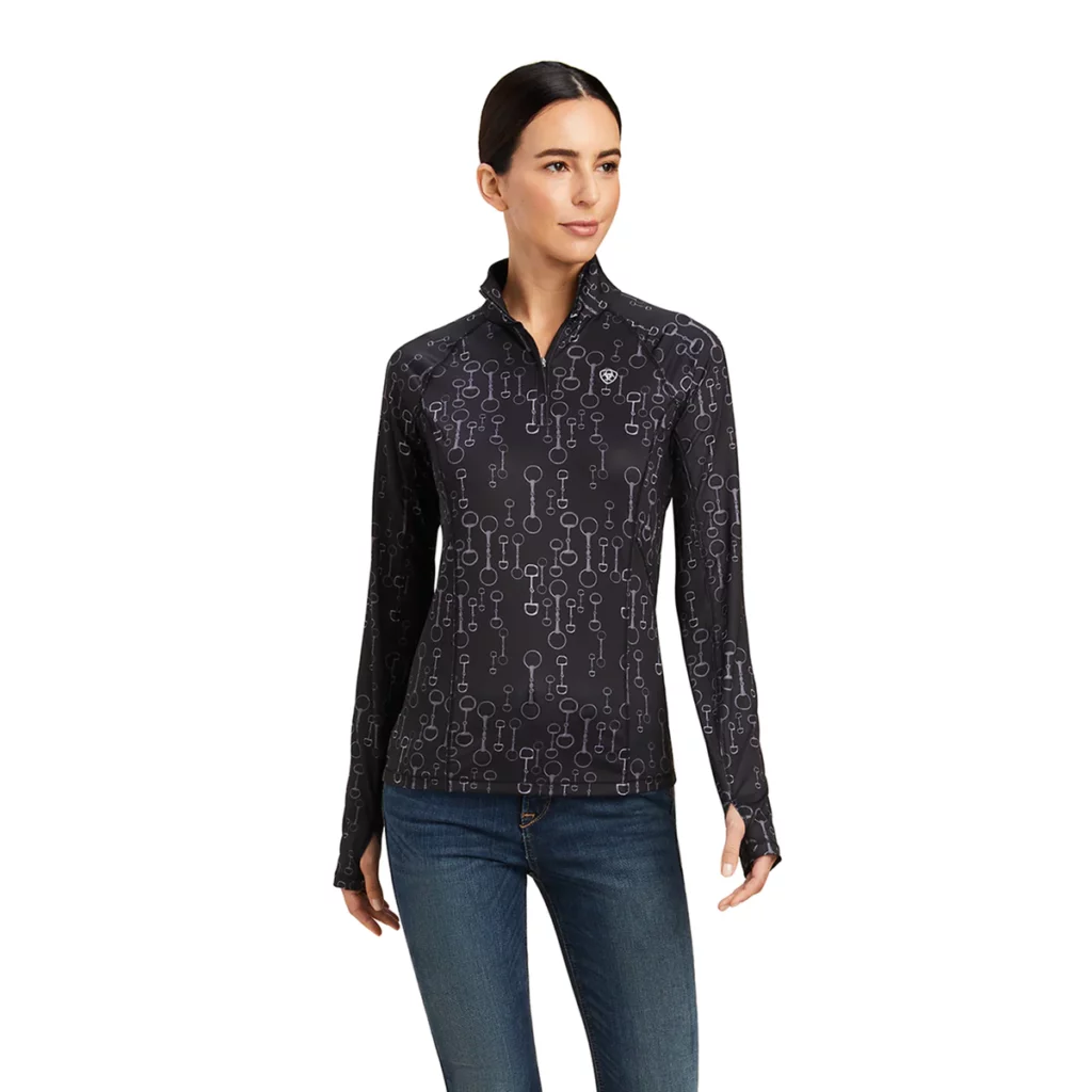 Woman wearing black Ariat baselayer with silver snaffle bit print 