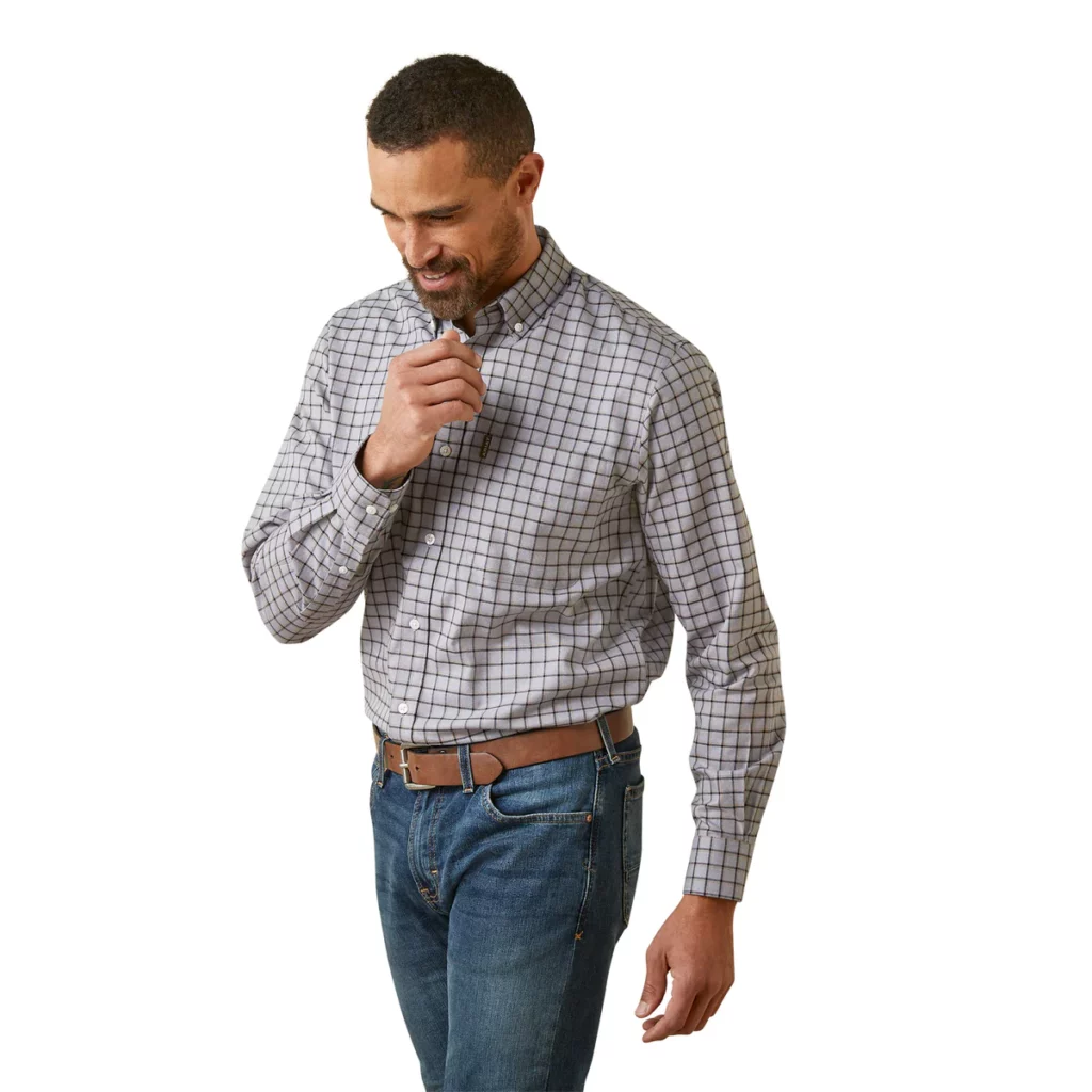 Man wearing a grey long sleeve collared shirt with checked pattern