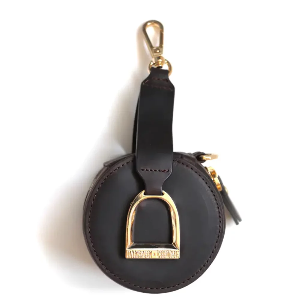 black leather accessory keeper key chain with a gold stirrup