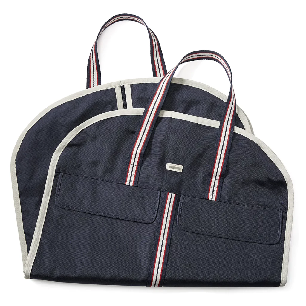 Navy Ariat garment bag with red, white, and navy striped handles 