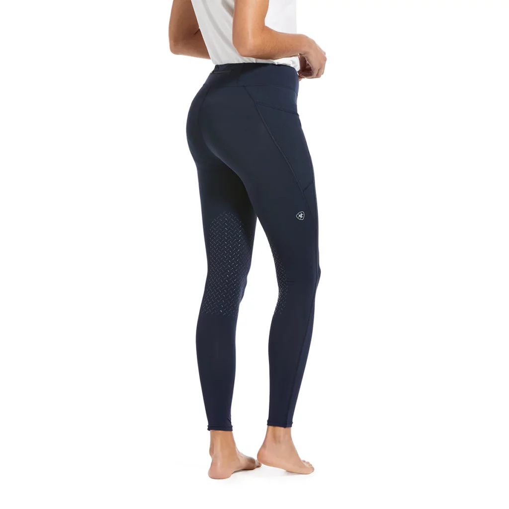 Navy knee-patch riding tights with small white Ariat logo on the thigh 