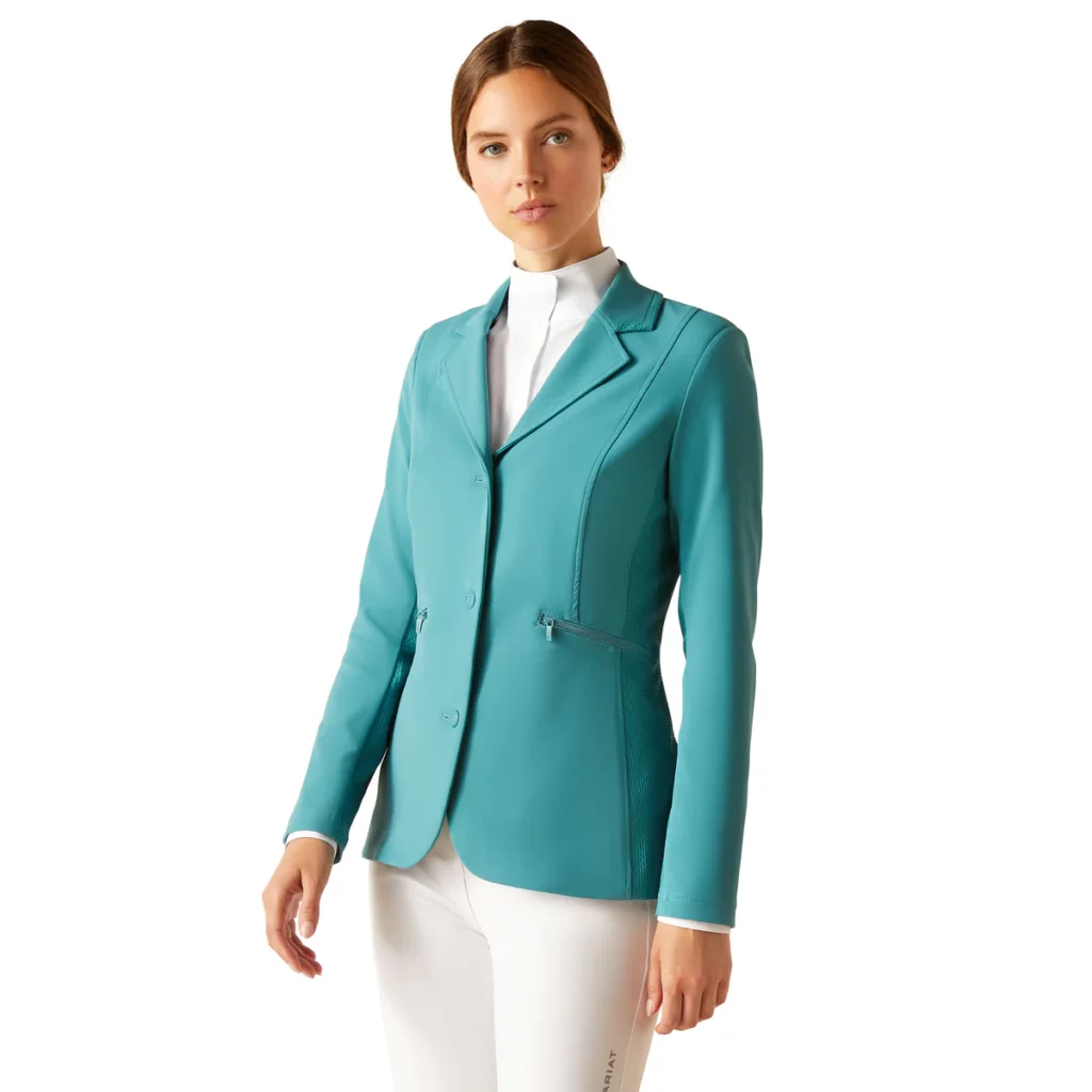 Woman wearing teal show coat with white breeches 