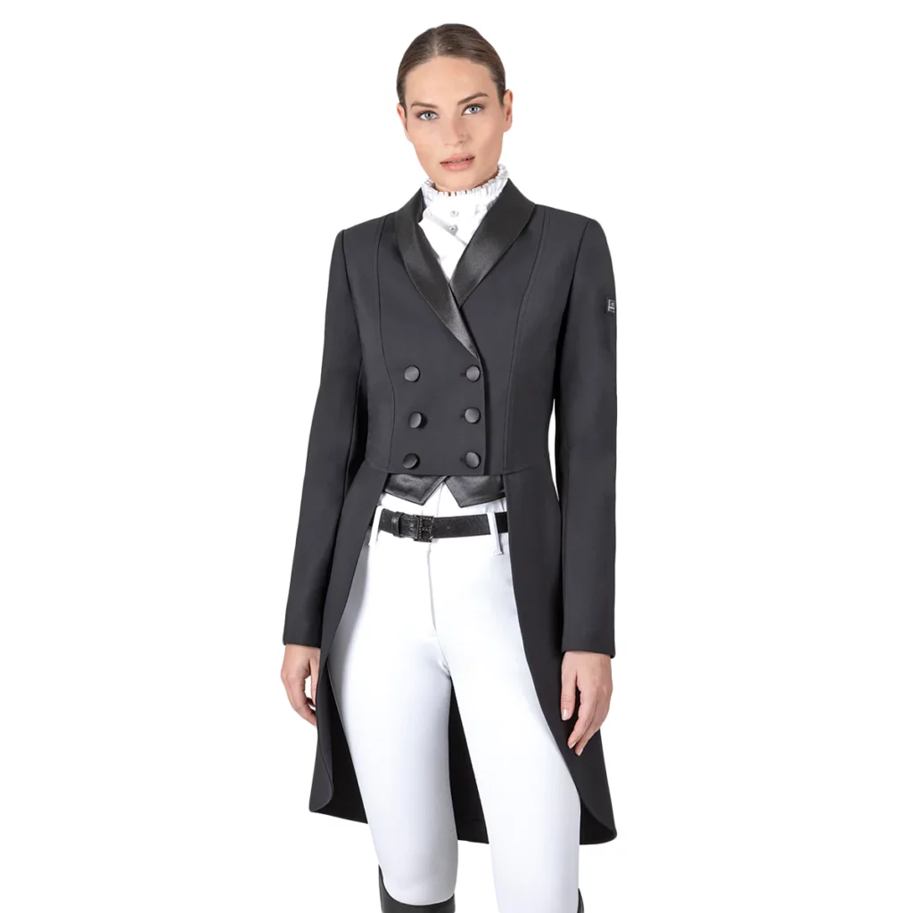 Woman wearing a dark grey shadbelly and white breeches 