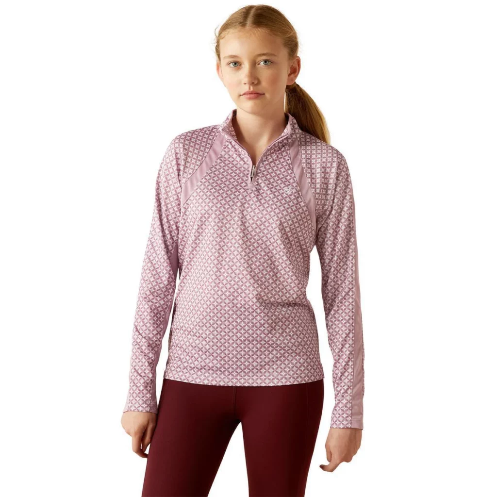 Girl wearing long lavender patterned long sleeve 1/4 zip baselayer