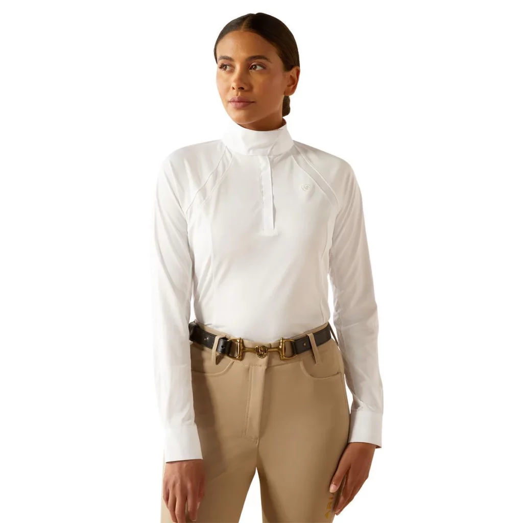 Woman wearing white long sleeve show shirt and tan breeches
