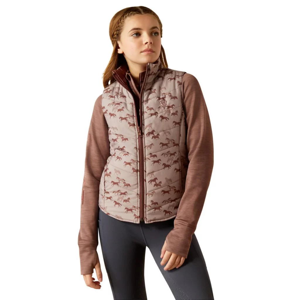 Girl wearing pink Bella Reversible Vest with a horse pattern